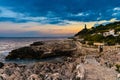 Sunset over rocky coast of Cap Ferrat cape with Phare Lighthouse near Saint-Jean-Cap-Ferrat resort town and Nice in France Royalty Free Stock Photo