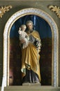 Saint Joseph holds the baby Jesus