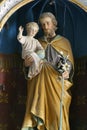 Saint Joseph holds the baby Jesus
