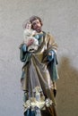 Saint Joseph holds baby Jesus