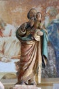 Saint Joseph holds a baby Jesus