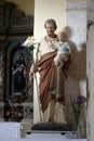 Saint Joseph holds a baby Jesus
