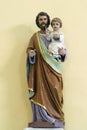 Saint Joseph holds the baby Jesus, a statue in the church of Saints Peter and Paul in Kasina, Croatia