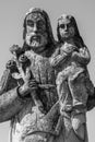 Saint Joseph with little Jesus Christ. Very ancient stone statue. White and black image Royalty Free Stock Photo