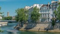 Saint-Louis bridge timelapse with houses on Orleans waterfront. Paris, France. Royalty Free Stock Photo