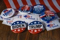 Saint Louis, MO--July 5, 2020; Biden democrat and Trump republican presidential campaign buttons from 2020 election sit on flag