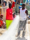 Unidentified Senegalese man holds a fishing net at the local ma Royalty Free Stock Photo