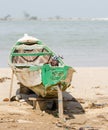 Saint-Louis, Senegal - October 20, 2013: Unidentified young African boy hiding in wooden boat and waving