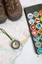Hiking boots compass and sash on map