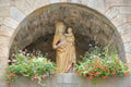 Close-up on the statue of the Virgin, nestled above the Grand Porte inside the walled city