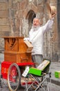 An old man with long white bread plays his street organ. Royalty Free Stock Photo
