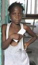 SAINT MARC, HAITI - FEB 22, 2013: A solemn girl leaning against