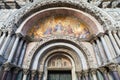 Saint Mark basilica facade details with golden, colorful mosaics in Venice