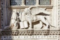 Saint Mark winged lion, white stone statue in sunlight in Venice Royalty Free Stock Photo