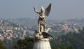 Saint Michael archangel full body sculpture city in the back Royalty Free Stock Photo