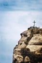 Saint Michael`s cross in Montserrat, Barcelona against a cloudy sky. Travel destination and religious symbol with empty copy space