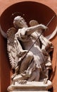 Saint Michael statue on the portal of St. Barnabas Church in Modena, Italy