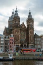 Saint Nicholas Basilica the major Catholic church in Old center District and typical Dutch houses, Amsterdam, The Netherlands, 13 Royalty Free Stock Photo