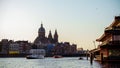 Saint Nicholas Basilica the major Catholic church in Old center District and typical Dutch houses and tour boats, Amsterdam, The Royalty Free Stock Photo