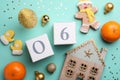 Saint Nicholas Day. Blocks with date December 06, sweets and festive decor on turquoise background, flat lay Royalty Free Stock Photo