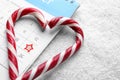 Saint Nicholas Day. Heart shape frame of candy canes and calendar with marked date December 19 on snow, closeup Royalty Free Stock Photo