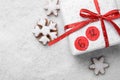 Saint Nicholas Day. Wrapped gift box with date December 6 and snowflake shape gingerbread cookies on snow, flat lay. Space for Royalty Free Stock Photo