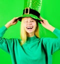 Saint Patrick day celebration. Happy blonde woman in green top hat at Patrick& x27;s day party. Closeup portrait of Royalty Free Stock Photo