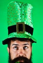 Saint Patrick day celebration. Pensive man in green top hat at Patrick& x27;s day party. Closeup portrait serious bearded Royalty Free Stock Photo