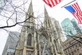 Saint Patrick`s Cathedral Church in New York City, USA. External View of Catholic Cathedral in Manhattan. US Flags Waving Proudly Royalty Free Stock Photo