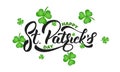 Saint Patrick`s Day. Clover shamrock leaves background and St. Patrick`s lettering. St. Patricks Day background Royalty Free Stock Photo