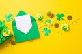 Top view photo of open green envelope with paper sheet meringue candies sprinkles gold coins present box and clovers Royalty Free Stock Photo