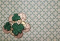 St. Patrick`s Day Themed Background with Gold Coins and Green Shamrocks on Patterned Green Backdrop