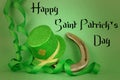 Saint Patrick`s Day image of sparkly green and gold leprechaun hat with curls of green and gold ribbon on a green background. Royalty Free Stock Photo