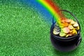 Saint Patrick`s Day and Leprechaun`s pot of gold coins concept with a rainbow indicating where the leprechaun hid treasure on Royalty Free Stock Photo