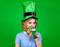 Saint Patricks Day celebration. Woman in Leprechaun hat drinking green beer. Patrick day pub party. Young blonde girl in Royalty Free Stock Photo