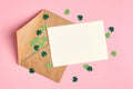 Saint Patricks day invitation card mockup with envelope, green paper shamrock on pink background Royalty Free Stock Photo