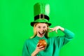 Saint Patricks Girl. Patricks woman in top green hat with pot of gold. Smiling woman in Leprechaun hat with pot of gold