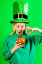 Saint Patricks Girl. Surprised woman in Leprechaun hat with pot of gold. Happy St Patricks Day. Amazed girl holds pot Royalty Free Stock Photo
