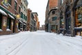 Saint Paul street in old port Montreal on a winter day, road covered in snow with no peopl Royalty Free Stock Photo