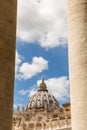 Saint Peter`s Dome seen through the Bernini Colonnade in St. Peter`s Square, Vatican City. Royalty Free Stock Photo