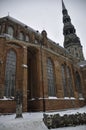 Saint Peter Snowy Church in Riga, Latvia. The red brick church with a Gothic tower in the old town is one of the symbols of Riga Royalty Free Stock Photo