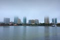 Saint Petersburg, Florida, buildings cityscape along the blue water shoreline of Tampa Bay on a very overcast foggy morning Royalty Free Stock Photo