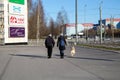 Saint-petersburg, Russia - 4 April 2020: Couple walk with a dog. People are staying home because of coronavirus