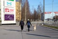 Saint-petersburg, Russia - 4 April 2020: Couple walk with a dog. People are staying home because of coronavirus
