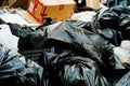 A pile of black dirty and crumpled garbage bags Royalty Free Stock Photo