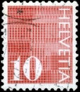 Saint Petersburg, Russia - April 30, 2020: Postage stamp issued in the Switzerland with the image of the Digits 10 on patterned