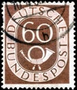 Saint Petersburg, Russia - April 14, 2020: Stamp issued in the Germany with the image of Digits with Posthorn, circa 1951