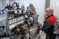 Test bench for checking the injection pump of an industrial diesel engine. Glass flasks with diesel fuel. Measuring scale,