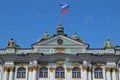 Sunny day in Saint-Petersburg, russian flag flying above facade of Hermitage State Museum Royalty Free Stock Photo