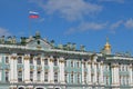 Sunny day in Saint-Petersburg, russian flag flying above facade of Hermitage State Museum Royalty Free Stock Photo